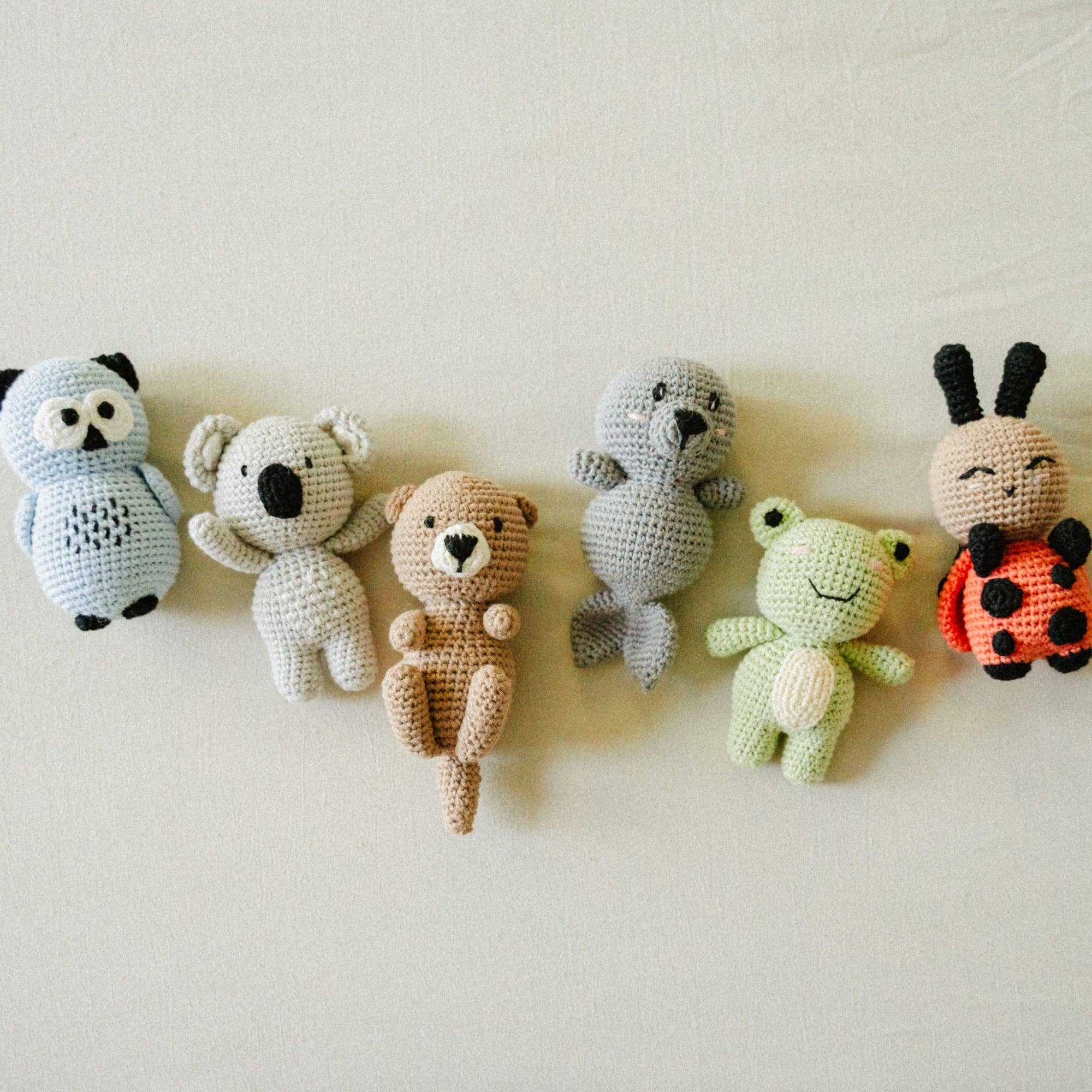 Handmade crochet animal toys including Suzie the Snuggle Buggle ladybug, inspired by 'Baby Zoo, I Love You' for babies and toddlers.