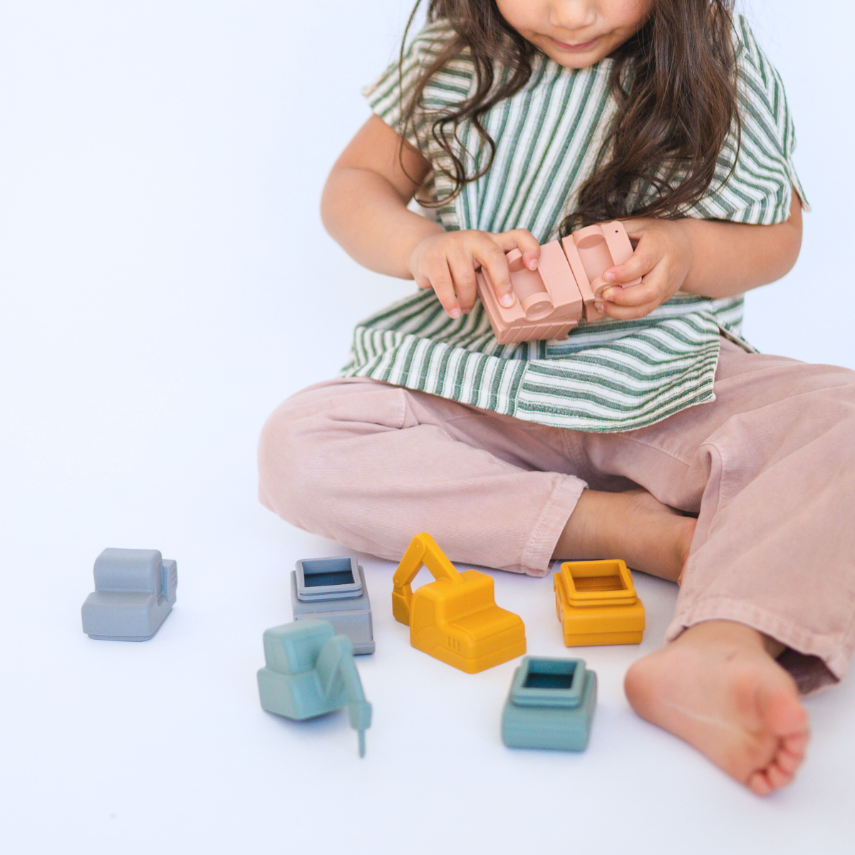 Child playing with Bug + Bean Kids Vehicle Silicone Bath Toy Set, featuring eco-friendly toy vehicles for imaginative water play.