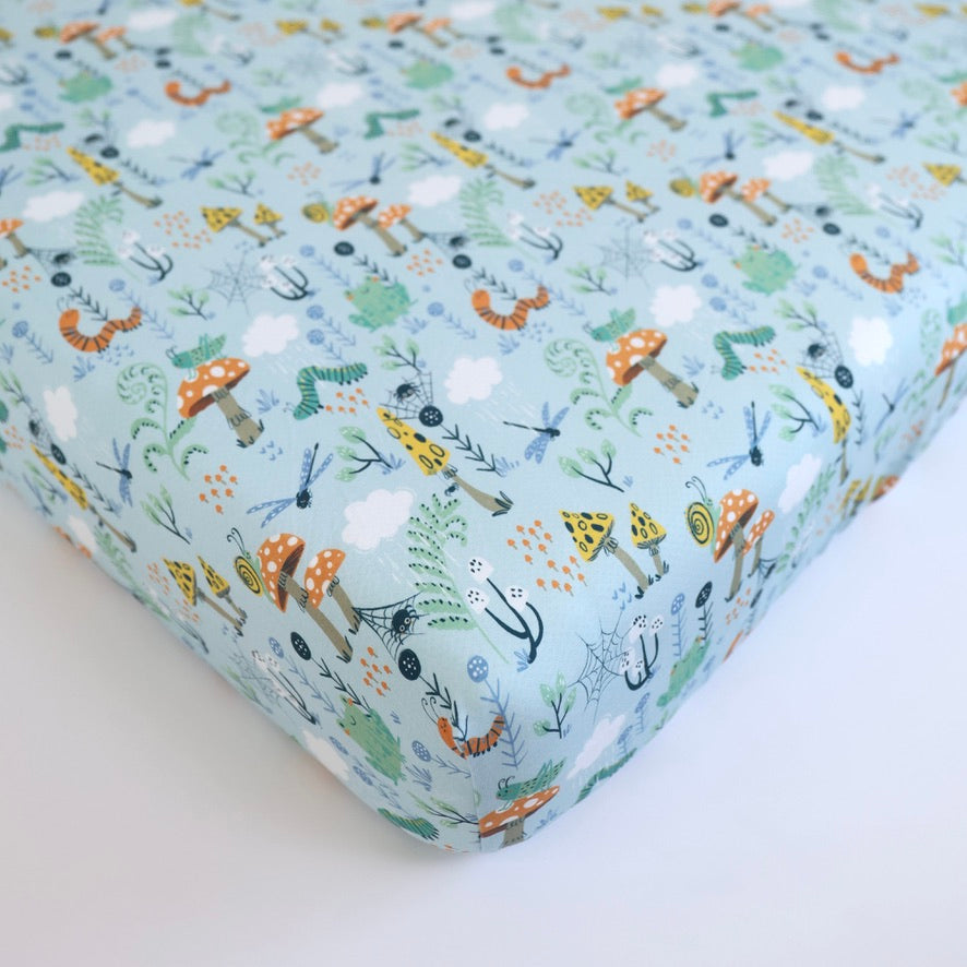 Critter Hollow crib sheet by Rainn in playful forest pattern, perfect for cozy, breathable sleep for babies.