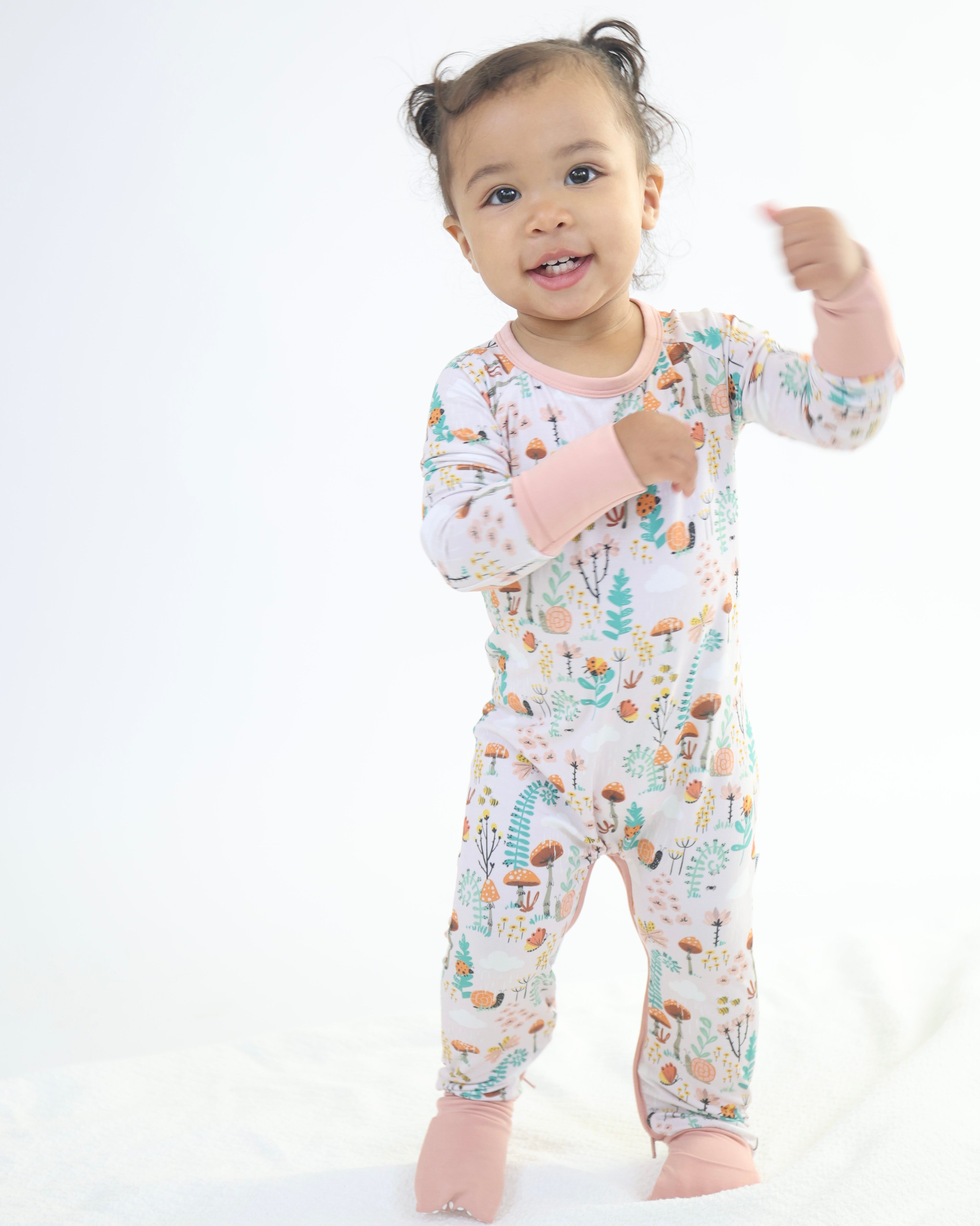 Toddler wearing bamboo crescent zipp jammies with fern print, showcasing breathable, hypoallergenic fabric ideal for sensitive skin.