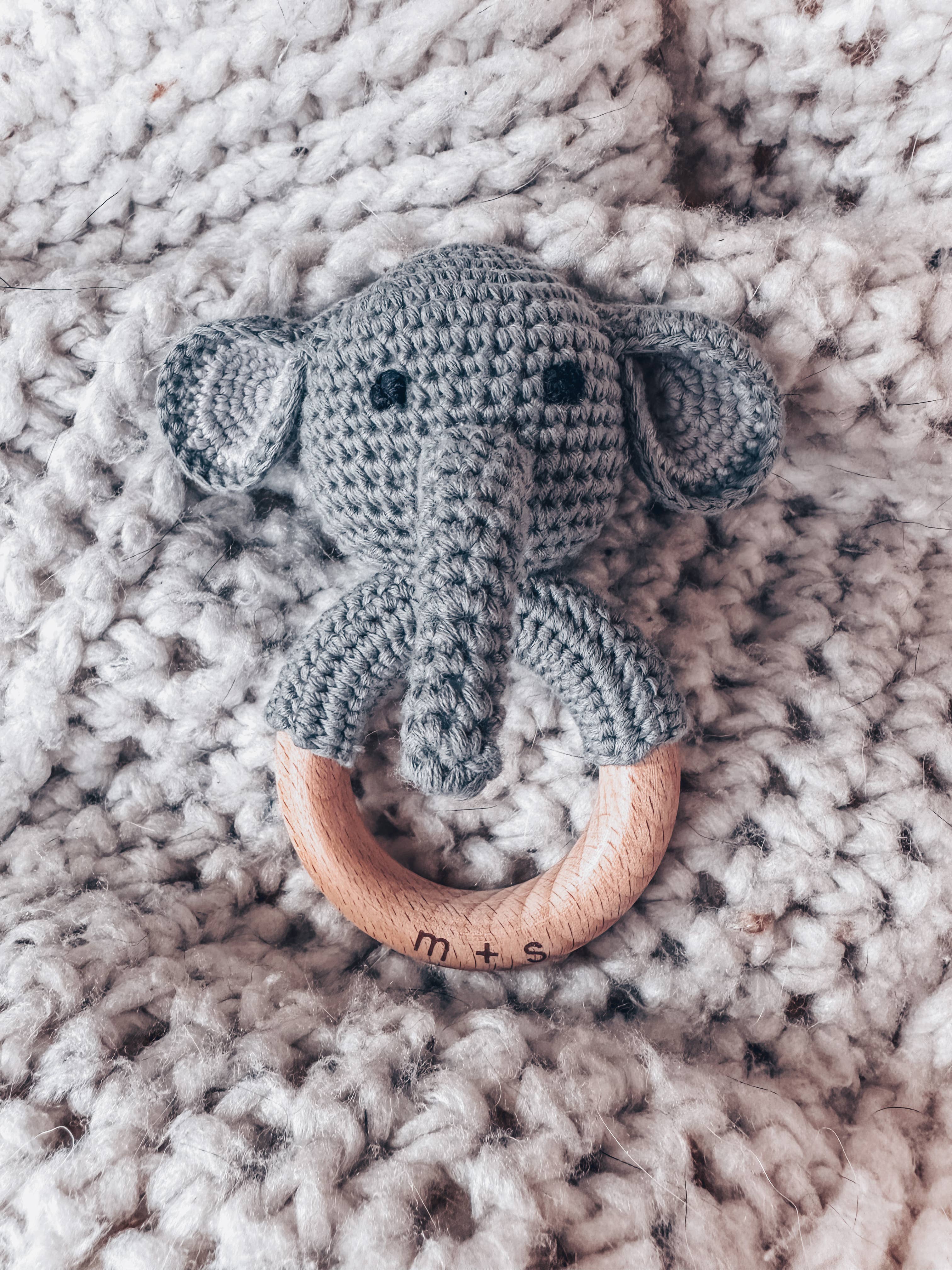 Handmade elephant crochet teether with wooden ring, perfect for sensory play for babies and toddlers.