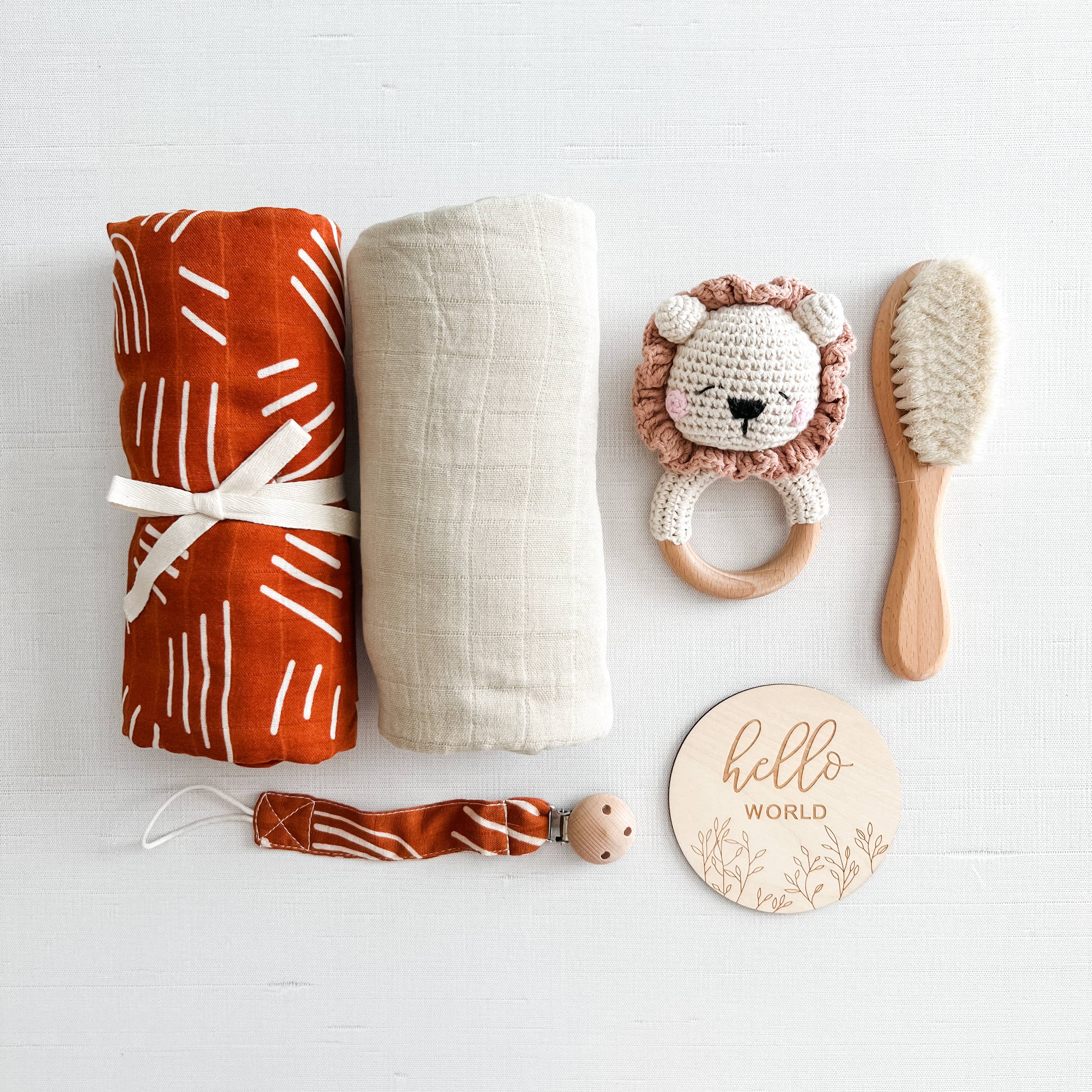 Coco Stripes Terra Newborn Gift Set with blankets, lion rattle, brush, and pacifier clip, boho-inspired for baby comfort.