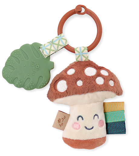 Itzy Pal™ plush mushroom character with green silicone teether and colorful ribbon, perfect for soothing little ones.