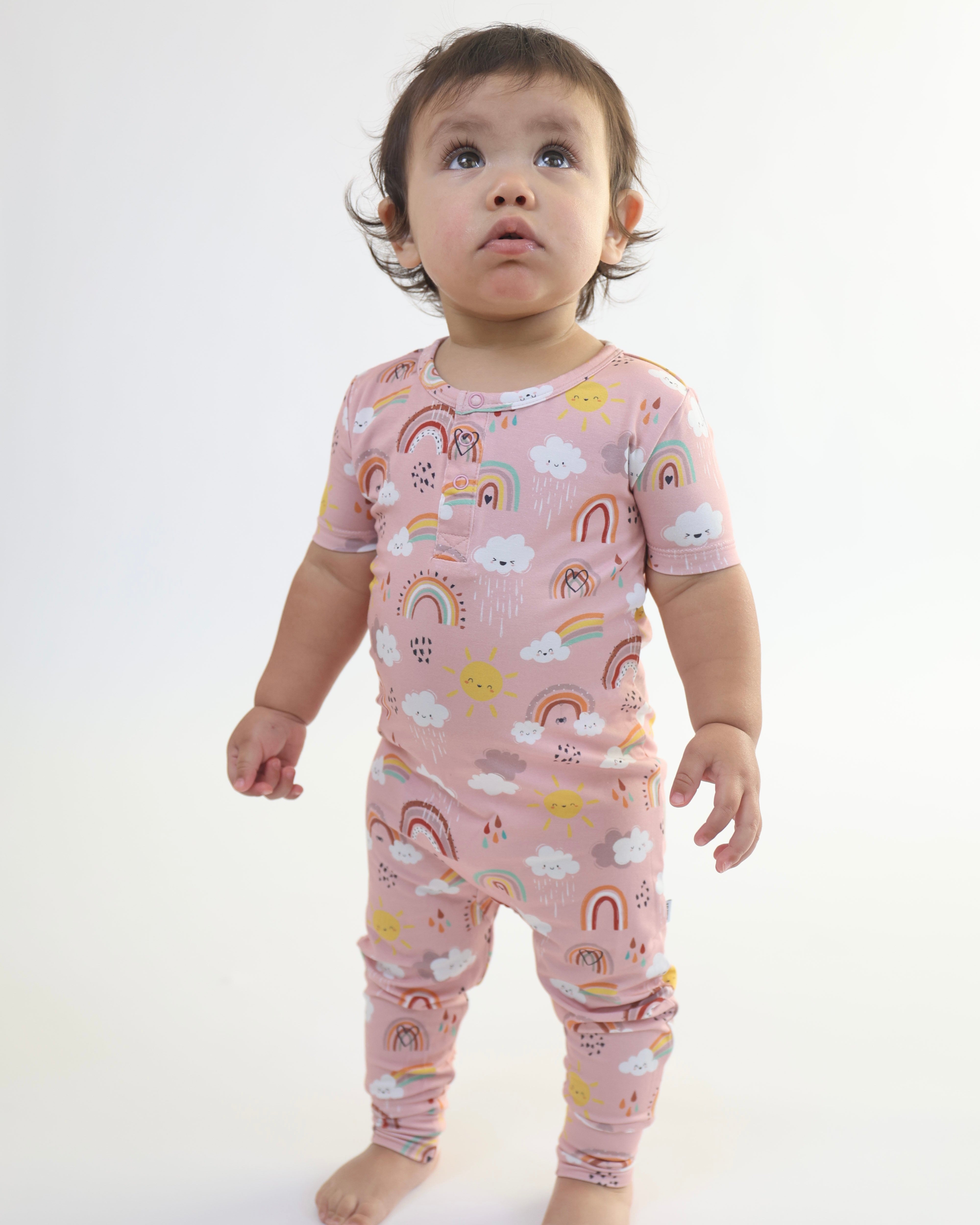 Toddler wearing a soft, breathable rainbow-printed bamboo romper, perfect for active play and easy changes.