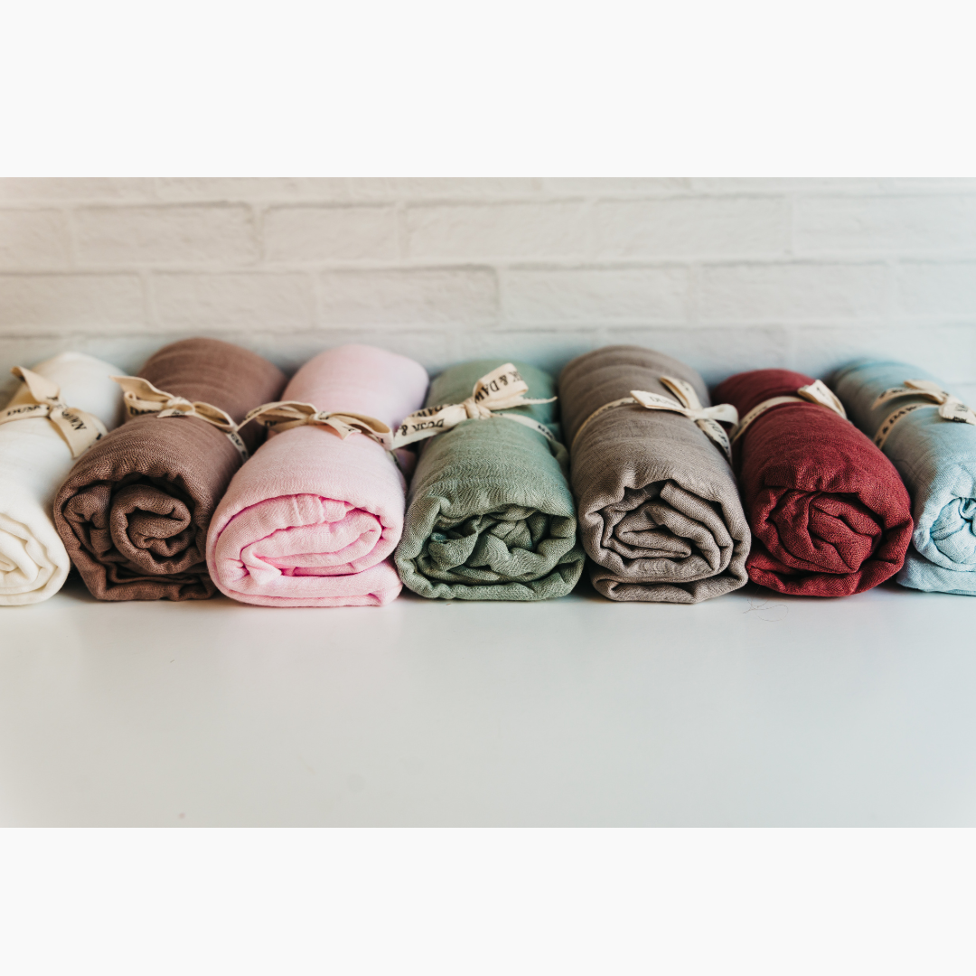 Colorful bamboo muslin baby swaddles by Giften Market, showcasing softness and sustainability for newborn comfort.