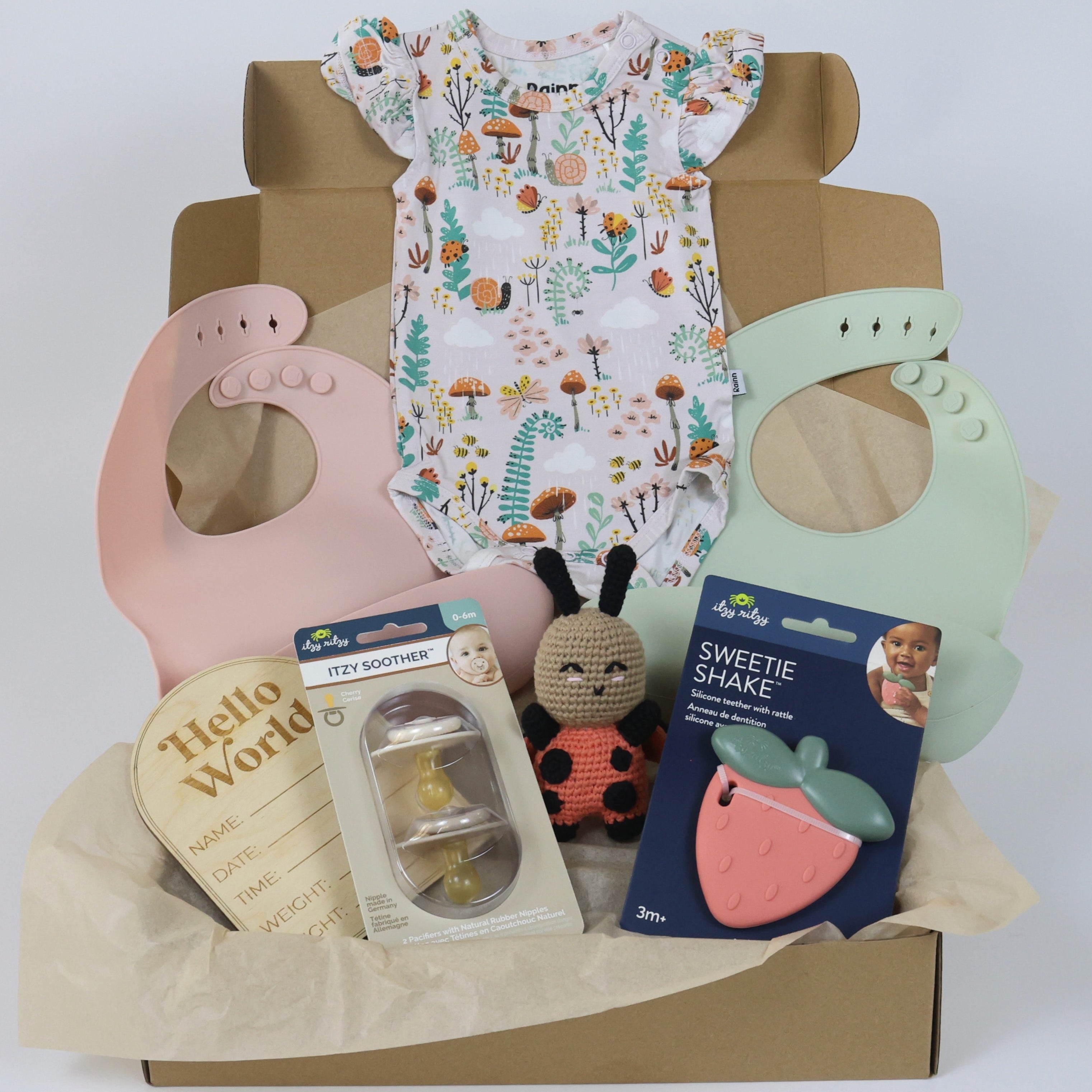 Baby Gift Set featuring a soft bamboo romper, silicone bibs, a toy, and fun accessories for little adventurers.